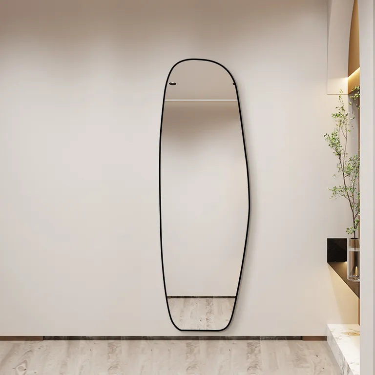 Specchio da ingresso con sottile cornice metallica e curve organiche